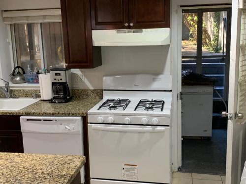 a white stove top oven in a kitchen at Renovated English Basement 2bdrm Home near METRO in Washington, D.C.