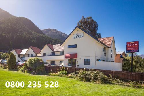 a hotel with a sign in front of a building at Bella Vista Queenstown in Queenstown