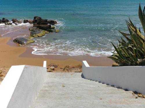 a staircase leading to a beach with the ocean at Le case di Fiò in Sciacca