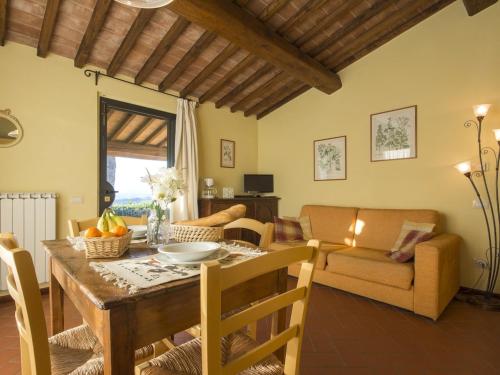 a kitchen and living room with a table and chairs at Hideaway Near San Gimignano in Bagnolo