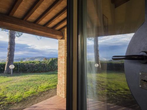 a sliding glass door with a view of a yard at Hideaway Near San Gimignano in Bagnolo