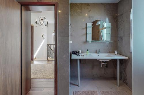 a bathroom with a sink and a mirror at Lighthouse Luxe Estate Apart & Villas in Balchik