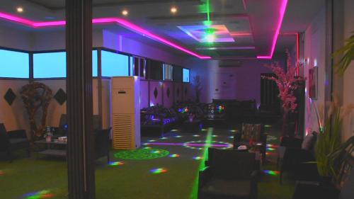 a room with purple and green lights on the ceiling at Florida Inn Hotel in Najran
