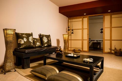 a living room with a couch and a table at Sol Arrayan Hotel & Spa in Villa La Angostura