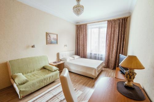 a living room with a couch and a bed at TRUSThome in Minsk