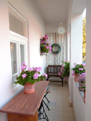 a room with a table with flowers on it at Ribizli Vintage Vendégház in Parád