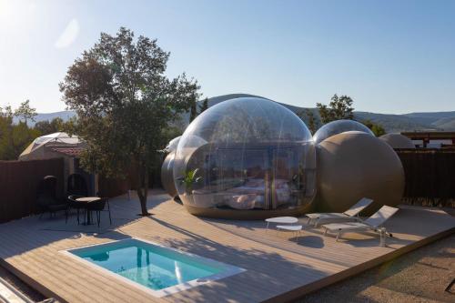 una gran casa de cristal en una terraza con piscina en Zielo de Levante, en 