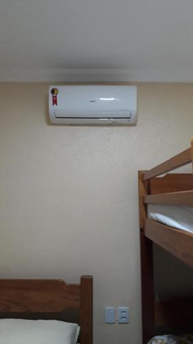 a bedroom with a air conditioner on the wall at Pousada Restaurante Sol de Liz in Fortaleza