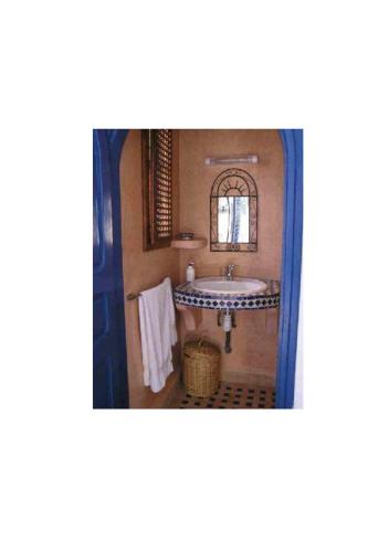 a bathroom with a sink and a mirror at Dar Al Bahar in Essaouira