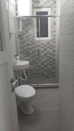 a bathroom with a toilet and a sink and a shower at Apartman Pavlovic in Leskovac
