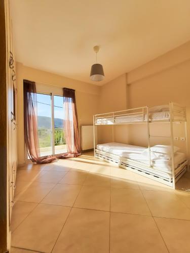 a bedroom with two bunk beds and a window at Elegant apartment with mountain view in Stavrákion