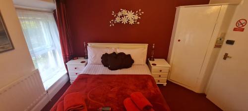 a small bedroom with a bed and a window at Holly Cottages in Bowness-on-Windermere