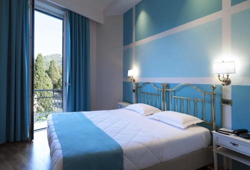 Postel nebo postele na pokoji v ubytování Hotel Settentrionale Esplanade
