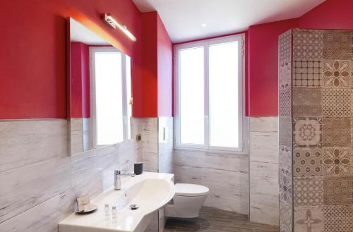 a bathroom with a white sink and a toilet at Hotel Settentrionale Esplanade in Montecatini Terme