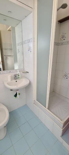 a bathroom with a toilet and a sink and a shower at La casa sul mare in Lipari