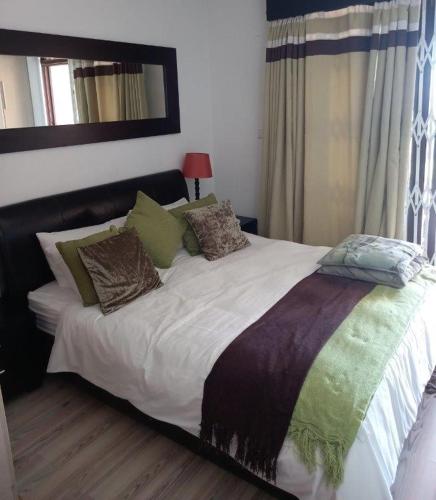 a large bed with pillows on it in a bedroom at Ocean Breeze 23 in Kingsborough