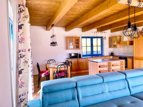 a living room with a blue couch in a kitchen at Chalupa Julia Staré Hutě in Horní Stropnice