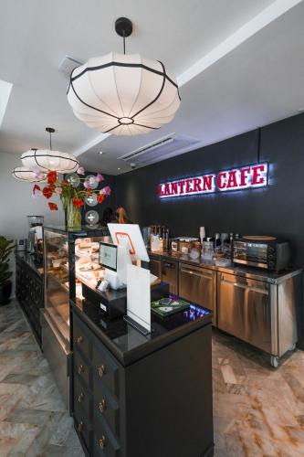 a kitchen cafe with a sign on the wall at The Lantern Hatyai Hotel in Hat Yai