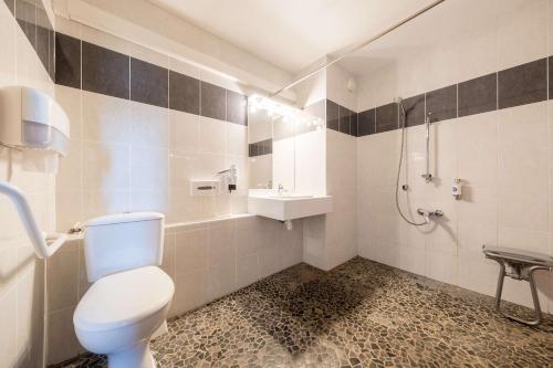 a bathroom with a toilet and a sink and a shower at Comfort Hotel Dijon Sud - 21600 LONGVIC in Dijon