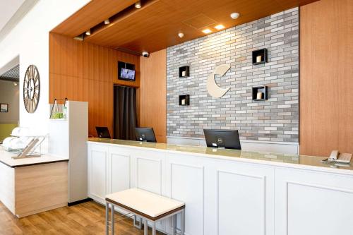 a lobby with a counter with two laptops on it at Comfort Hotel Toyama in Toyama
