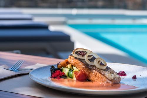 a plate with a piece of food on a table at Riviera Boutique Hotel in Stalida