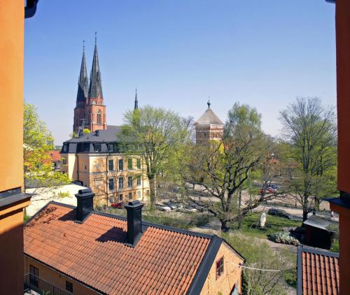 a view of a city with buildings and a church at Akademihotellet in Uppsala