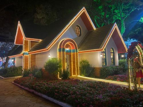 a church lit up at night with christmas lights at FIKA Residence in Dois Irmãos