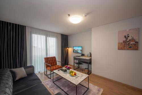 a living room with a couch and a table at KA Hotel & Suites in Istanbul