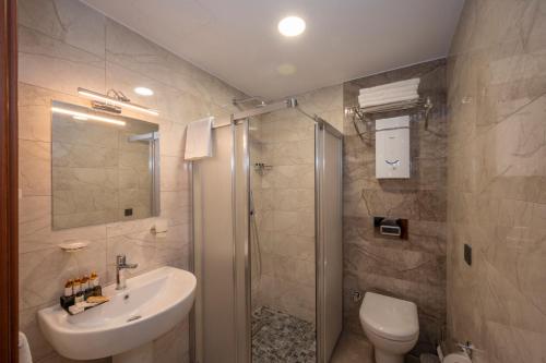 a bathroom with a toilet and a sink and a shower at KA Hotel & Suites in Istanbul