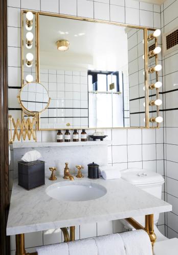 a bathroom with a sink and a mirror at The Ludlow Hotel in New York