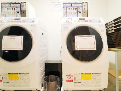 two washing machines are standing next to each other at Odawara Terminal Hotel in Odawara