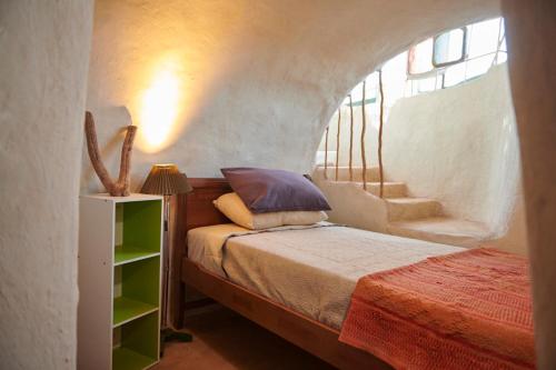 a bedroom with a bed and a stair case at CASA PEQUÉN in San Pedro de Atacama