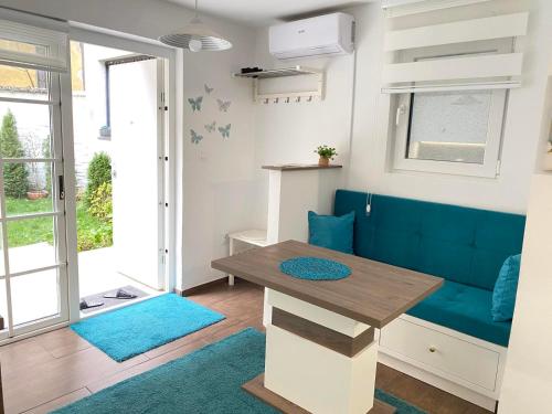 a living room with a blue couch and a table at Apartment Dalia in Sarajevo