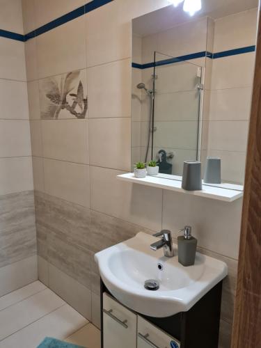 a bathroom with a sink and a mirror at Apartmány Bystrá-Chopok in Brezno