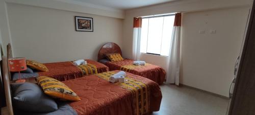 Ein Bett oder Betten in einem Zimmer der Unterkunft INTI SUMAQ WASI