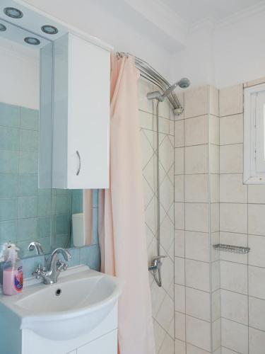 a bathroom with a sink and a shower at Villa Leda in Karousádes