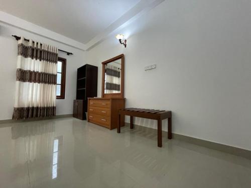 a living room with a dresser and a mirror at ilamparuma Hotel in Weligama