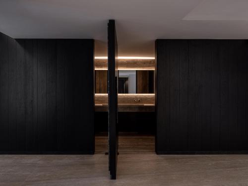 a room with two black cupboards and a table at The Tanneries Hotel & Spa - a Member of Design Hotels in Chania Town
