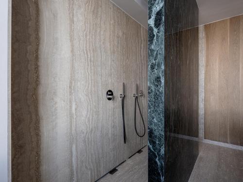 a shower with a wooden door in a bathroom at The Tanneries Hotel & Spa - a Member of Design Hotels in Chania Town