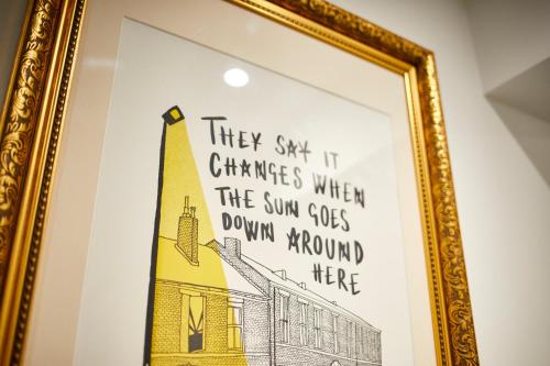 a picture of a building in a gold frame at Three Cranes Serviced Apartments in Sheffield