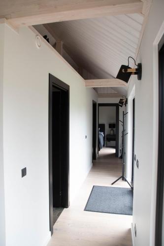a hallway of a house with white walls and a ceiling at Pärli puhkemaja / Pearl riverside house in Pudisoo
