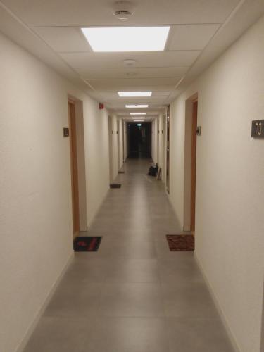 an empty hallway of an office building with a long corridor at Róża- Lotnisko in Wrocław