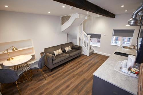 a living room with a couch and a table at Three Cranes Serviced Apartments in Sheffield