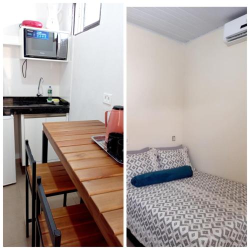 a room with a table and a bed and a kitchen at kitnet completa no Centro in Carolina