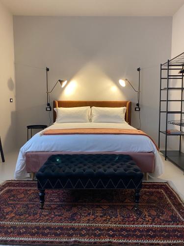 a bedroom with a large bed and a rug at Casimiro Rooms in Cesena