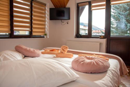a bed with two teddy bears sitting on top of it at Casa Albert Sinaia in Sinaia
