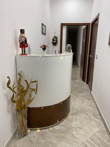 a lobby with a white counter and a vase of flowers at Toledo Point in Naples