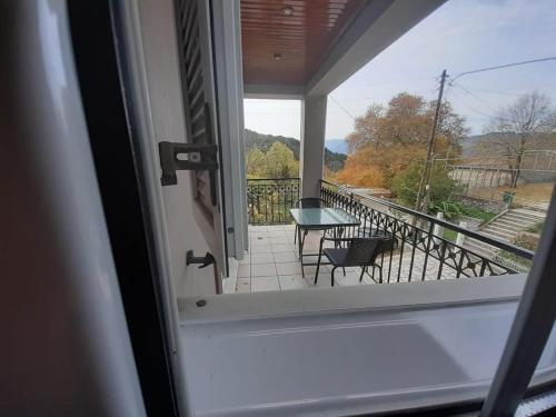 a view from a window of a balcony with a table and chairs at Tzoumerka in Ktistádes