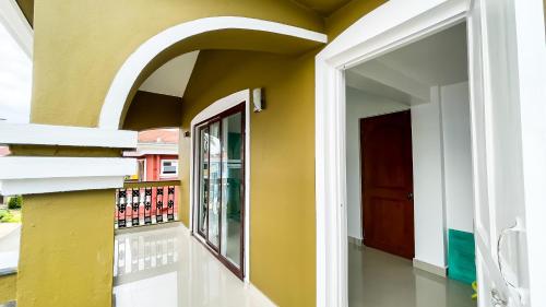 a hallway of a house with a door and a window at Calvin's Retreat in Varca