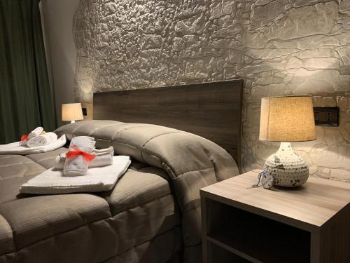 a bedroom with a bed and a table with a lamp at Villa Anna GuestHouse in Brindisi